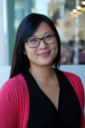 Image features Amanda in a pink cardigan over a black blouse